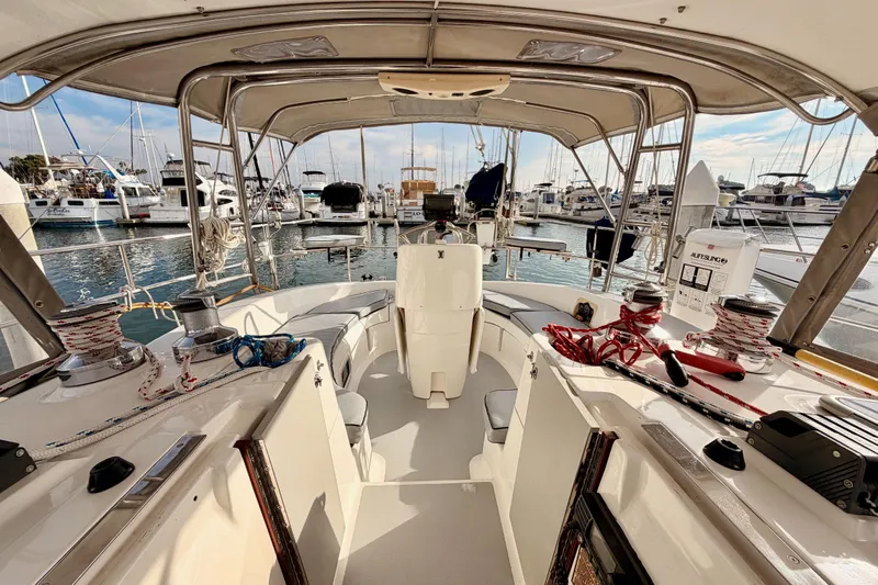 Serendipity II Yacht Photos Pics Cockpit view of 2002 Hunter 460 sailboat docked at marina, showcasing seating and equipment.