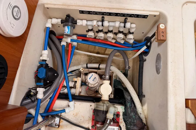 Serendipity II Yacht Photos Pics Plumbing system of a 2002 Hunter 460 boat, featuring pipes and valves.