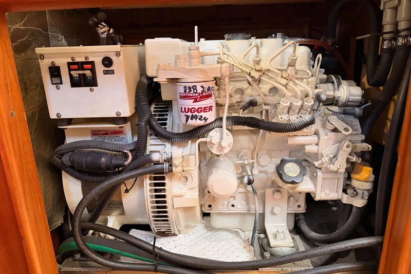 Serendipity II Yacht Photos Pics Engine compartment of a 2002 Hunter 460 sailboat, featuring a Lugger marine engine.