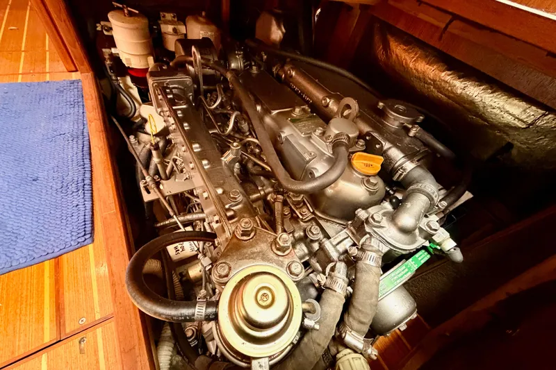 Serendipity II Yacht Photos Pics Engine compartment of a 2002 Hunter 460 sailboat, showcasing detailed mechanical components.