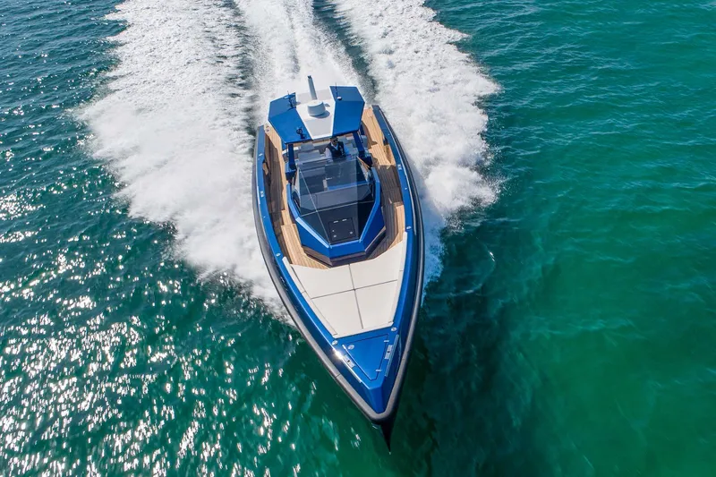 Rocket Yacht Photos Pics 2022 Wally Tender 48X yacht cruising on clear blue water, aerial view.