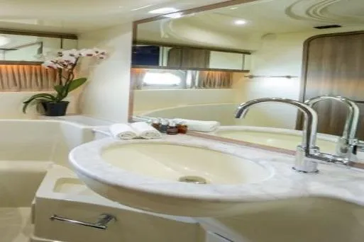  Yacht Photos Pics Luxurious bathroom in 2000 Ferretti Yachts 57, featuring elegant sink and decor.