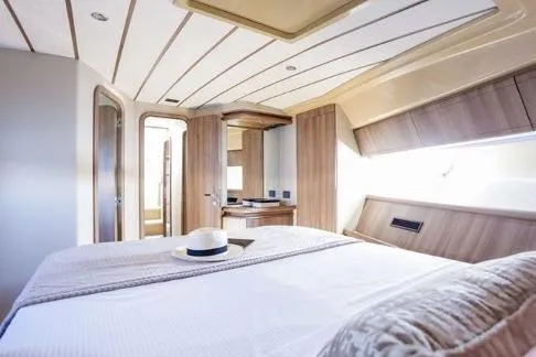  Yacht Photos Pics Luxurious cabin interior of 2000 Ferretti Yachts 57, featuring elegant wood finishes and natural light.