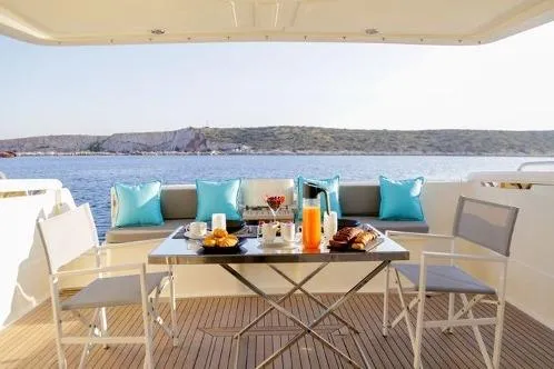  Yacht Photos Pics Luxury dining setup on 2000 Ferretti Yachts 57, overlooking serene waters.