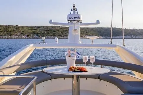  Yacht Photos Pics Luxurious 2000 Ferretti Yachts 57 with elegant dining setup on deck, overlooking serene waters.