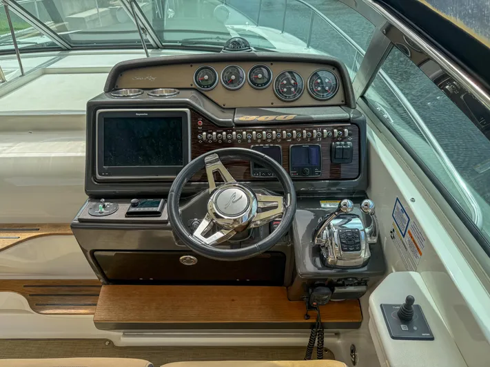  Yacht Photos Pics Cockpit of 2016 Sea Ray 350 Sundancer with steering wheel and control panel.