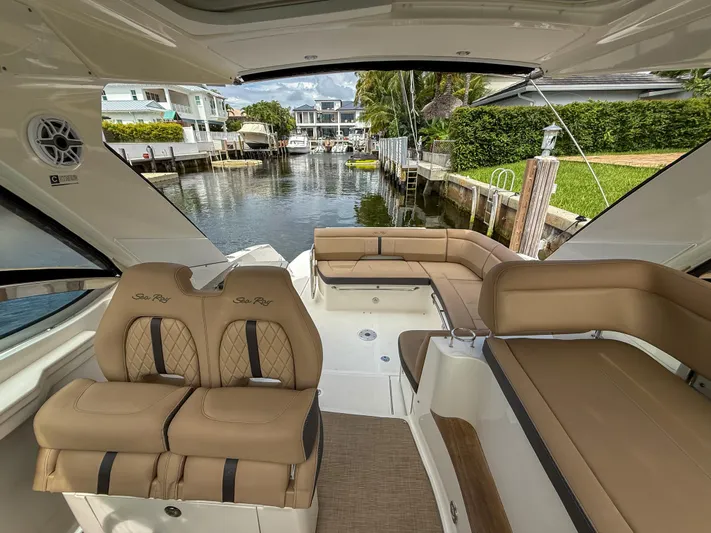  Yacht Photos Pics Interior view of 2016 Sea Ray 350 Sundancer yacht with luxurious seating and canal backdrop.