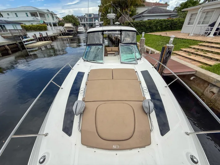  Yacht Photos Pics 2016 Sea Ray 350 Sundancer yacht docked in a residential canal setting.