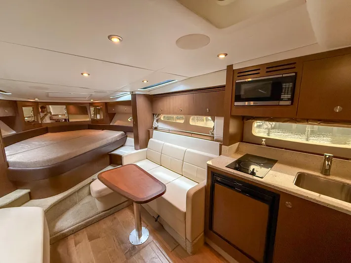  Yacht Photos Pics Interior of 2016 Sea Ray 350 Sundancer yacht with kitchen, seating, and bed.