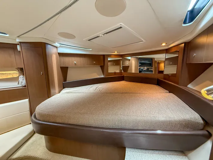  Yacht Photos Pics 2016 Sea Ray 350 Sundancer cabin interior with luxurious bed and wooden cabinetry.
