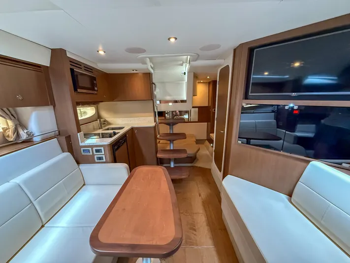  Yacht Photos Pics Interior of 2016 Sea Ray 350 Sundancer yacht with modern kitchen and seating area.