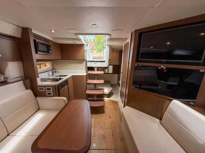  Yacht Photos Pics Interior of 2016 Sea Ray 350 Sundancer yacht with modern kitchen and seating area.