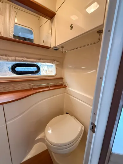  Yacht Photos Pics 2016 Sea Ray 350 Sundancer bathroom with modern fixtures and wood accents.