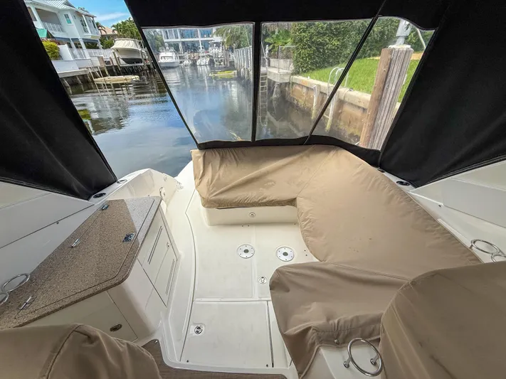  Yacht Photos Pics 2016 Sea Ray 350 Sundancer interior with seating, docked in a serene canal setting.