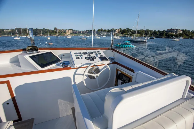 Huckins Yacht Corporation Yacht Photos Pics Helm of 1964 Huckins Out Islander 56 yacht with scenic harbor view.
