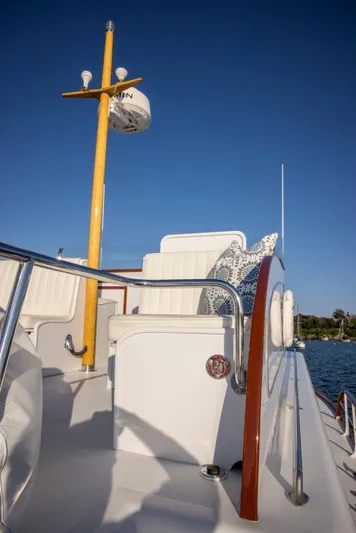 Huckins Yacht Corporation Yacht Photos Pics 1964 Huckins Out Islander 56 yacht deck with seating and clear blue sky.