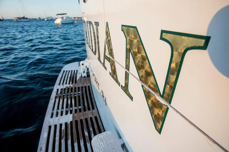 Huckins Yacht Corporation Yacht Photos Pics 1964 Huckins Out Islander 56 yacht on water, partial name visible, with boats in the background.