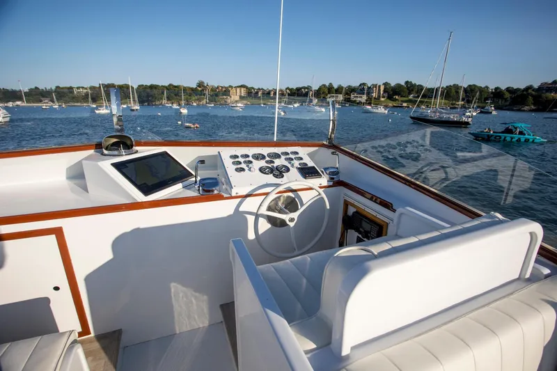 Huckins Yacht Corporation Yacht Photos Pics 1964 Huckins Out Islander 56 yacht helm with scenic harbor view.