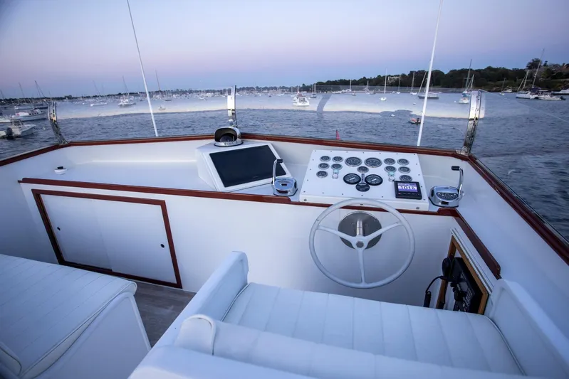 Huckins Yacht Corporation Yacht Photos Pics Helm of 1964 Huckins Out Islander 56 yacht with scenic harbor view.