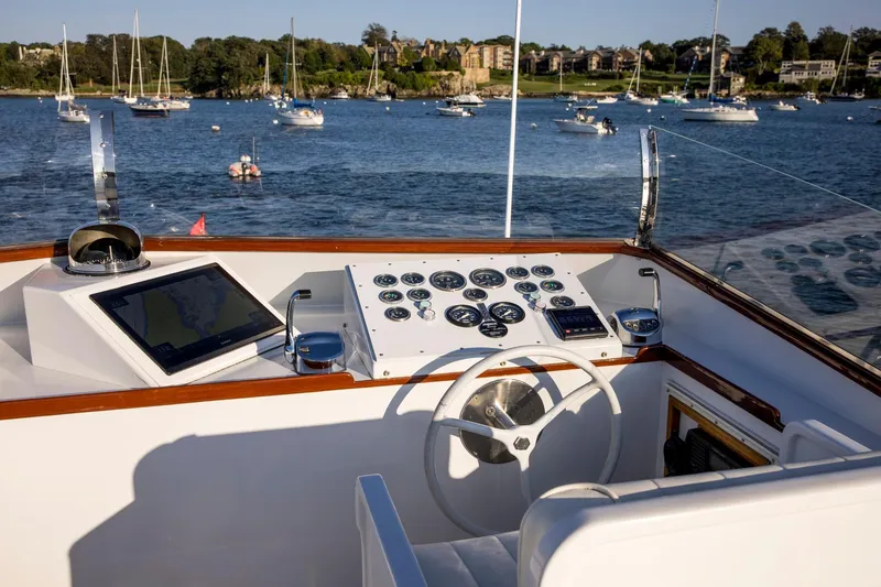 Huckins Yacht Corporation Yacht Photos Pics Helm of 1964 Huckins Out Islander 56 yacht with scenic harbor view.