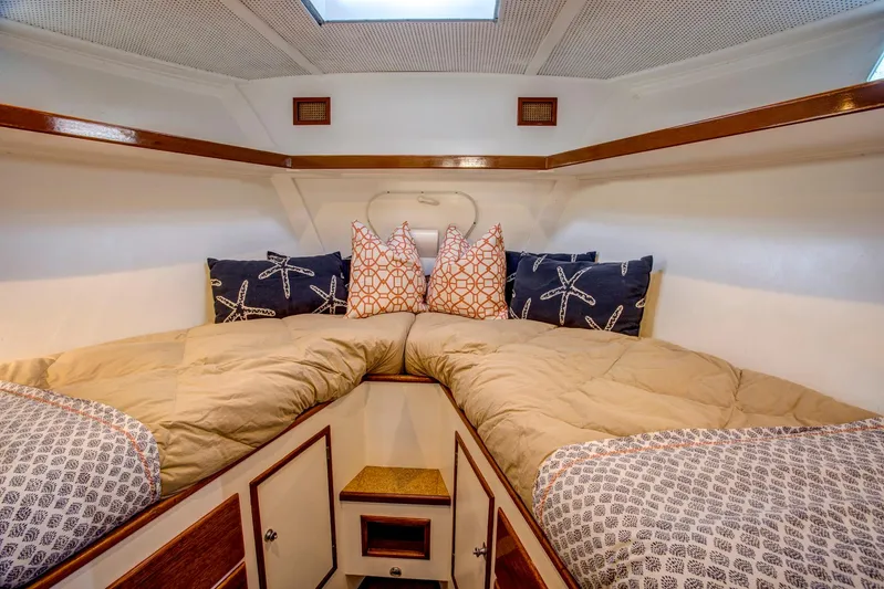 Huckins Yacht Corporation Yacht Photos Pics Cozy cabin interior of 1964 Huckins Out Islander 56 with nautical-themed pillows.