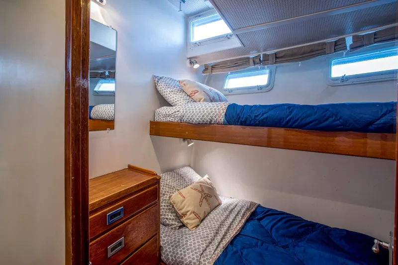 Huckins Yacht Corporation Yacht Photos Pics Bunk beds in 1964 Huckins Out Islander 56 yacht cabin with wooden drawers and nautical decor.