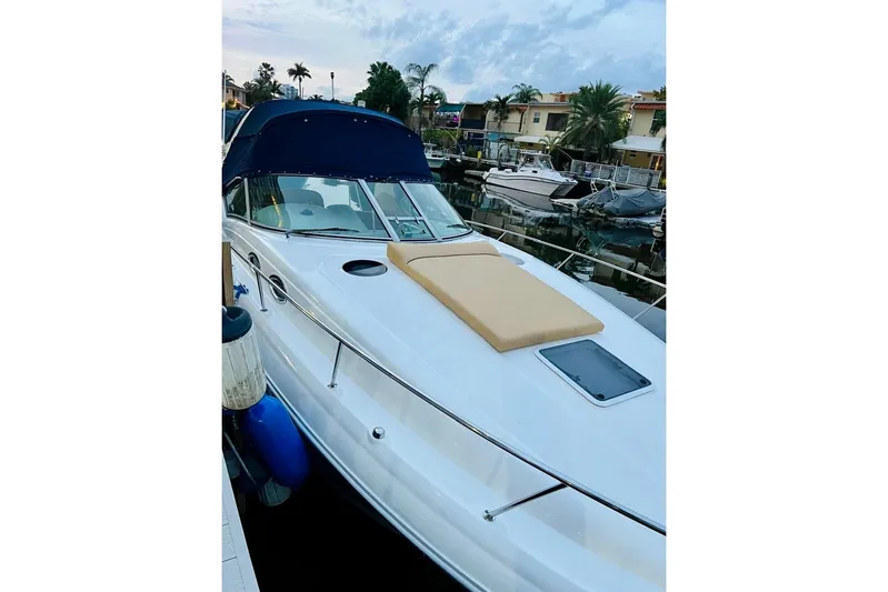  Yacht Photos Pics 2004 Sea Ray 320 Sundancer docked, featuring sleek design and spacious deck.