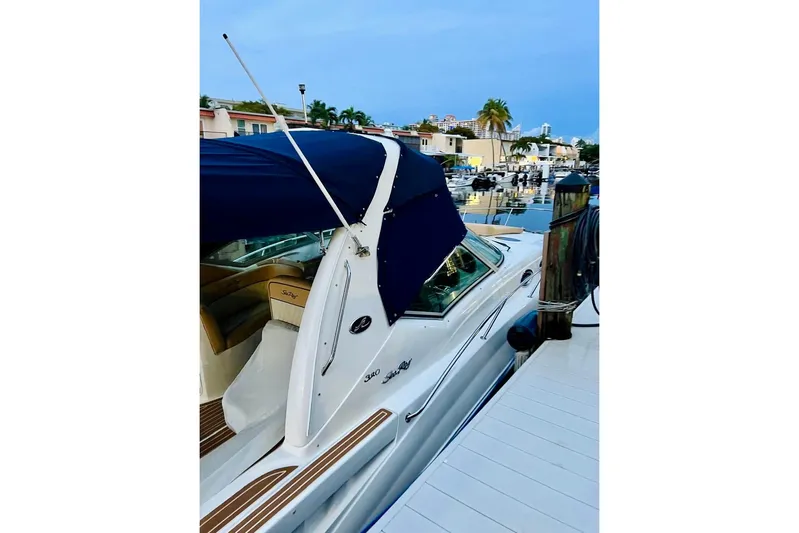  Yacht Photos Pics 2004 Sea Ray 320 Sundancer docked at marina with blue canopy.