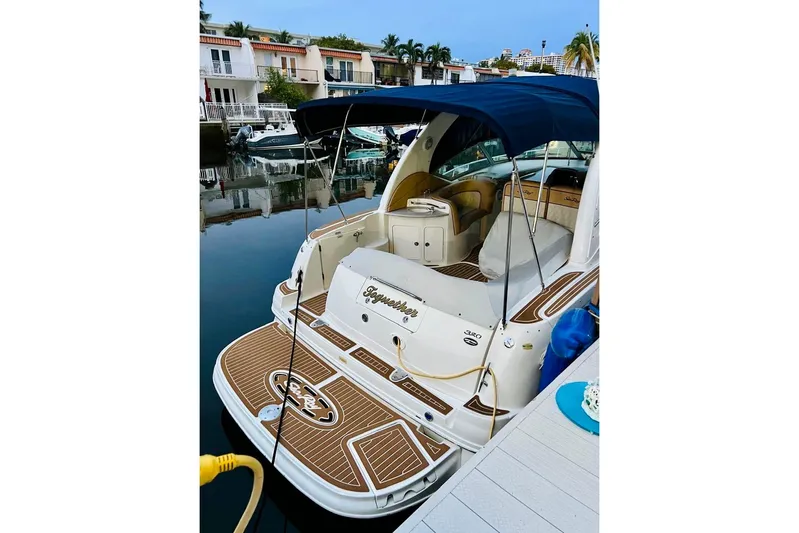  Yacht Photos Pics 2004 Sea Ray 320 Sundancer yacht docked, featuring a spacious deck and elegant design.