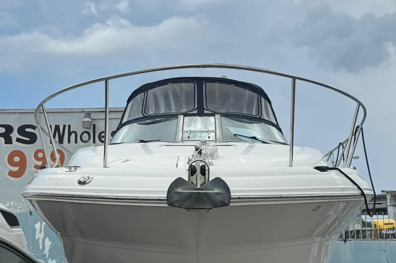  Yacht Photos Pics 2004 Sea Ray 320 Sundancer boat docked, front view with cloudy sky background.