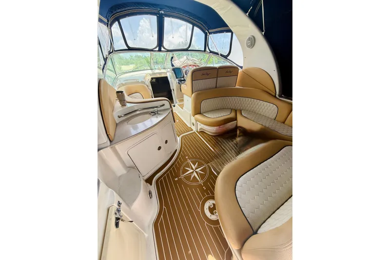  Yacht Photos Pics Luxurious interior of 2004 Sea Ray 320 Sundancer with elegant seating and wood flooring.