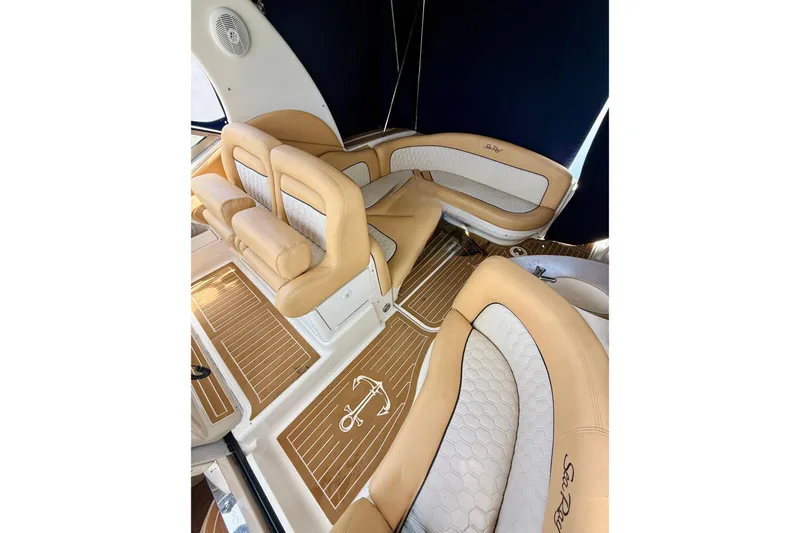  Yacht Photos Pics Luxurious interior of 2004 Sea Ray 320 Sundancer with tan and white seating.
