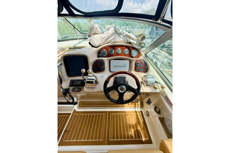  Yacht Photos Pics 2004 Sea Ray 320 Sundancer helm with Garmin navigation and wood-accented dashboard.