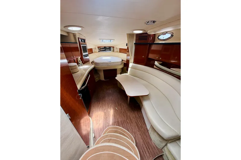  Yacht Photos Pics Interior of 2004 Sea Ray 320 Sundancer with elegant seating and wood finishes.