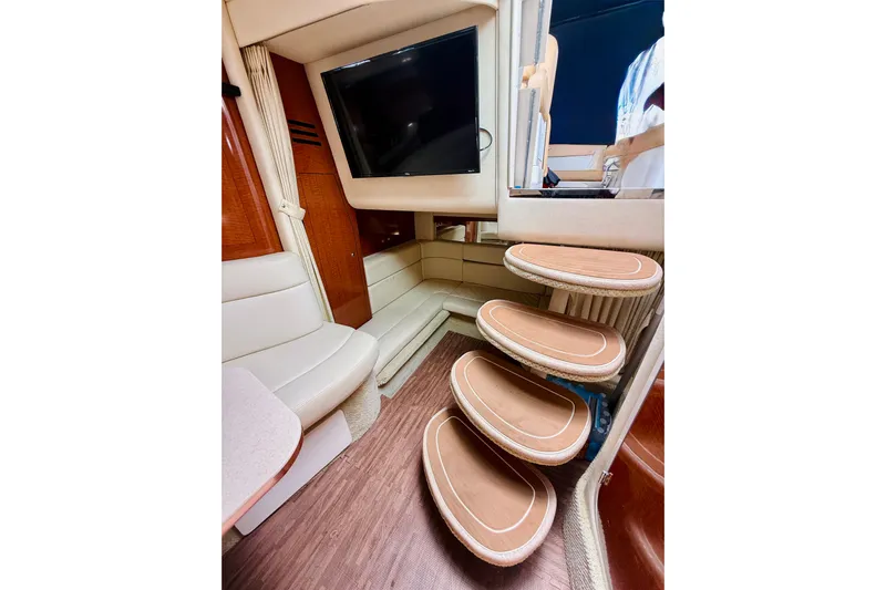  Yacht Photos Pics Interior of 2004 Sea Ray 320 Sundancer with wooden steps and seating area.