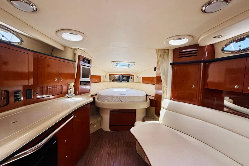  Yacht Photos Pics Luxurious interior of 2004 Sea Ray 320 Sundancer yacht with wood cabinetry and cozy seating.