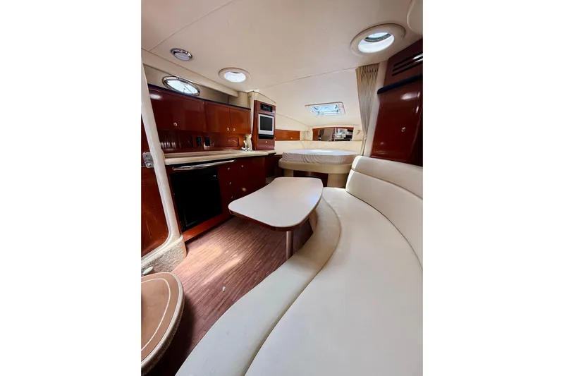  Yacht Photos Pics Interior of 2004 Sea Ray 320 Sundancer yacht with elegant seating and kitchenette.