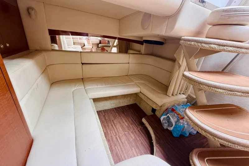  Yacht Photos Pics 2004 Sea Ray 320 Sundancer cabin interior with beige seating and wooden steps.