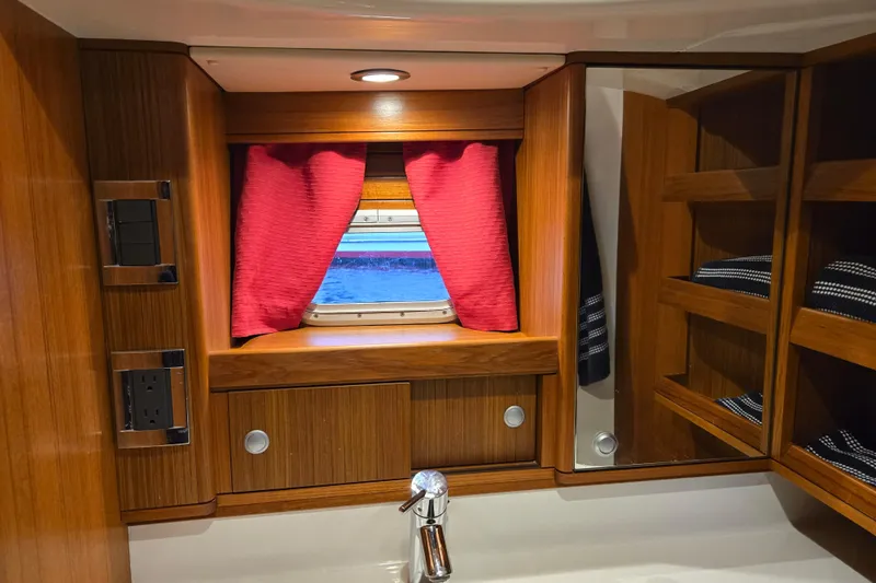 Kolea Yacht Photos Pics Luxurious Ron Holland 50 yacht interior with wooden cabinetry and red curtains, 2013 model.