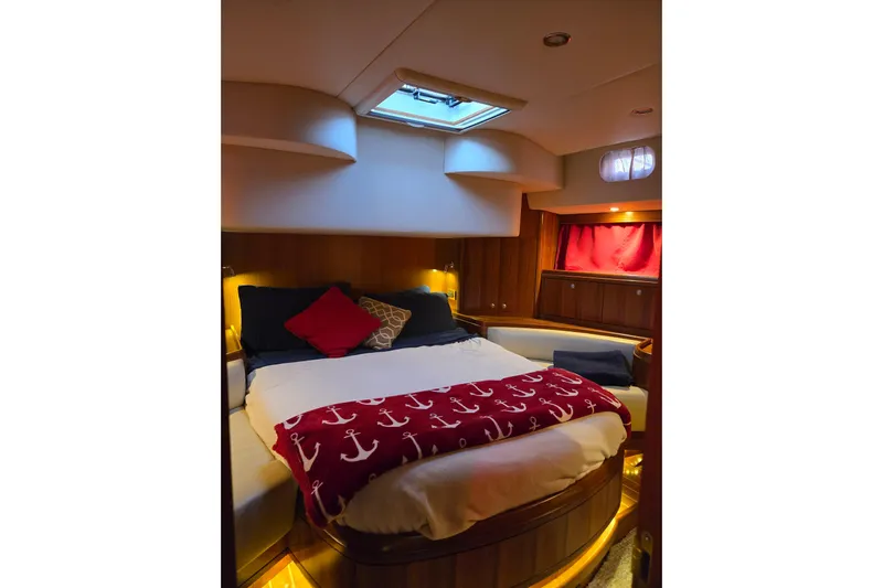 Kolea Yacht Photos Pics Luxurious cabin interior of 2013 Ron Holland 50 yacht with cozy bedding and ambient lighting.
