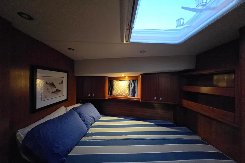 Kolea Yacht Photos Pics Cozy cabin interior of 2013 Ron Holland 50 yacht with skylight and striped bedding.