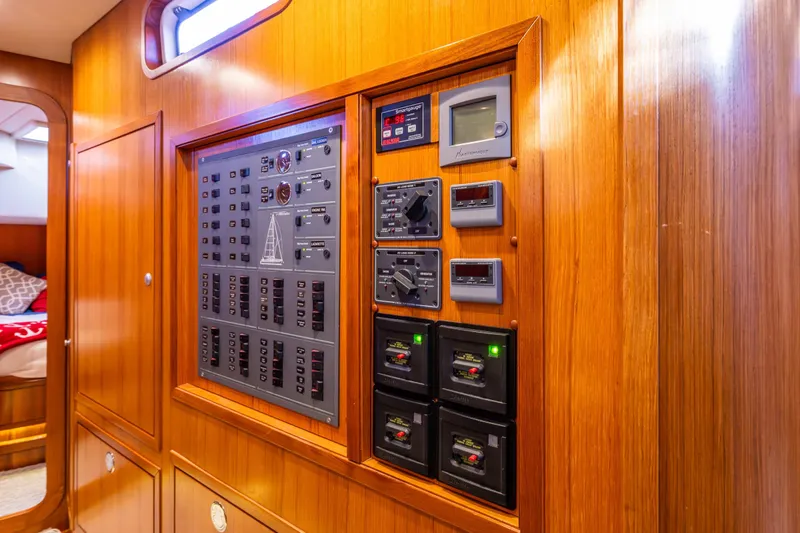 Kolea Yacht Photos Pics Control panel inside 2013 Ron Holland 50 yacht, featuring wooden interior and modern equipment.