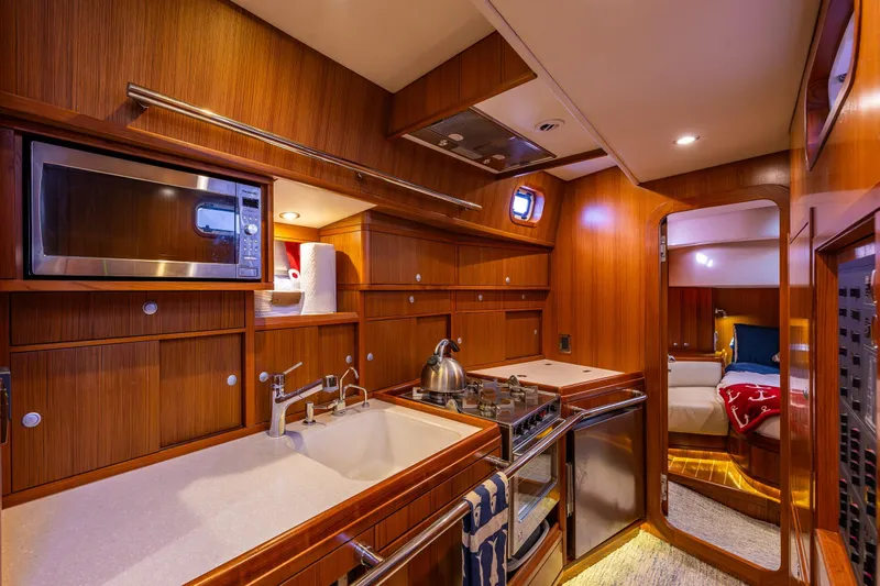 Kolea Yacht Photos Pics Luxurious Ron Holland 50 yacht interior kitchen with wood finish and modern amenities, 2013 model.