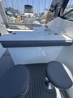 True Yacht Photos Pics 2020 Cruisers Yachts 38 GLS interior with seating and table, docked at marina.