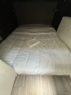 True Yacht Photos Pics 2020 Cruisers Yachts 38 GLS cabin interior with a neatly made bed.