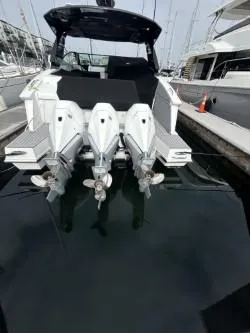 True Yacht Photos Pics 2020 Cruisers Yachts 38 GLS with triple outboard engines docked at marina.