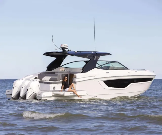 True Yacht Photos Pics 2020 Cruisers Yachts 38 GLS in water, featuring sleek design and triple outboard engines.