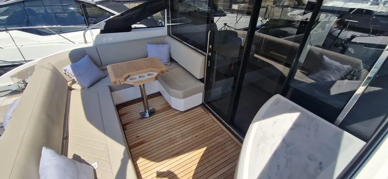 Seakeeper Gyro Yacht Photos Pics Luxurious 2022 Fairline Targa 45 GT yacht interior with elegant seating and wooden flooring.