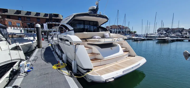 Seakeeper Gyro Yacht Photos Pics 2022 Fairline Targa 45 GT yacht docked at marina under clear blue sky.