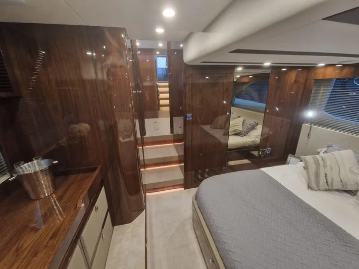 Seakeeper Gyro Yacht Photos Pics Luxurious interior of 2022 Fairline Targa 45 GT yacht with elegant wood finishes and cozy bedding.